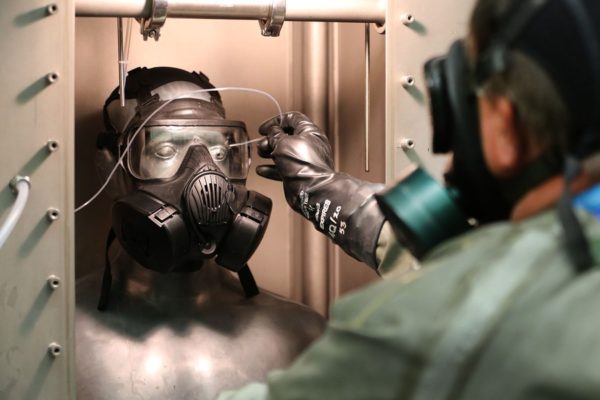 DUGWAY, UT - AUGUST 15: A technician in a gas mask takes measurement readings on the Smartman test dummy at the Smartman Laboratory facility at the U.S. Army's Dugway Proving Ground on August 15, 2017 in Dugway, Utah. Workers at this facility handle some of the most deadly and dangerous biological and chemical agents on earth. The 800,000-acre base in the middle of the Utah desert is a top secret facility that  tests and develops defensive measures to counter the effects of biological and chemical agents that may be used against the United States. (Photo by George Frey/Getty Images)