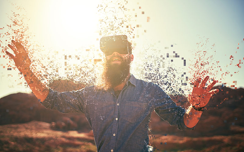 bearded guy in desert wearing vr glasses dissolving into pixels